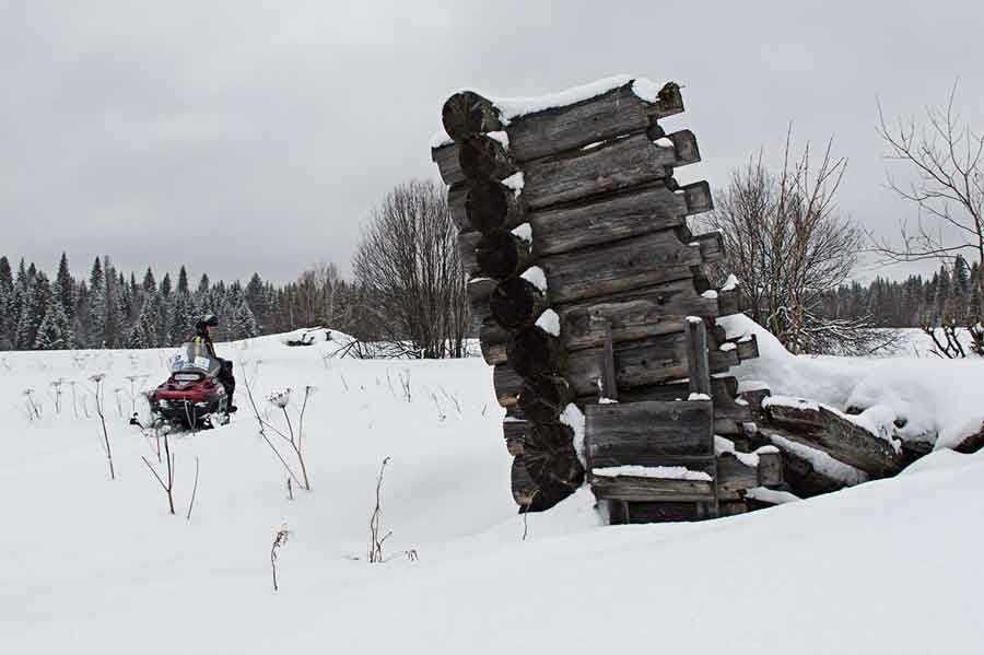 Remnants of log home Kytlym Russia during snowmobile adventure.