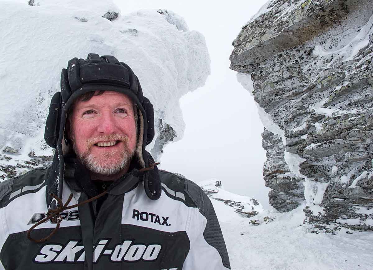 Dan Gould at Manpupuner rock formation during snowmobiling trip in Oslyanka Mountain in the Urals of Russia.