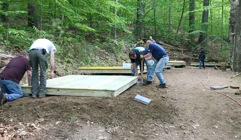 Volunteers install the new camp decks.