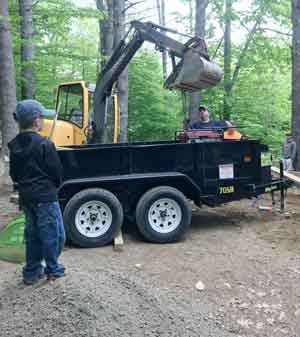 A young volunteer watches the action from a high vantage point.