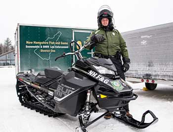 NH Fish and Game officer on snowmobile