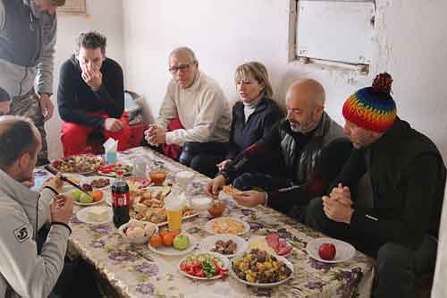 Snowmobilers eat dinner in Tian-Shan Mountains 