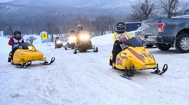 Children snowmobile in NH