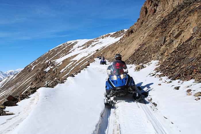 Aldo Cereser snowmobile along Soviet road in Arabel Valley Pass.