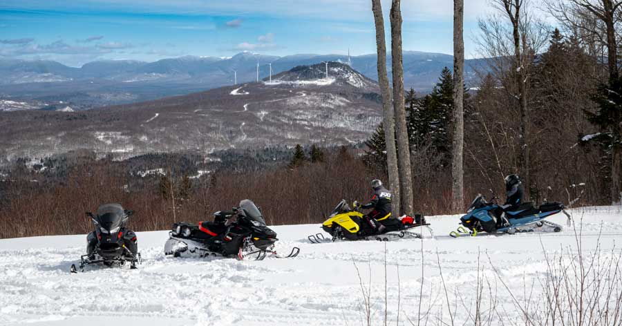 Snowmobilers at Jerhico State Park look at windmills.