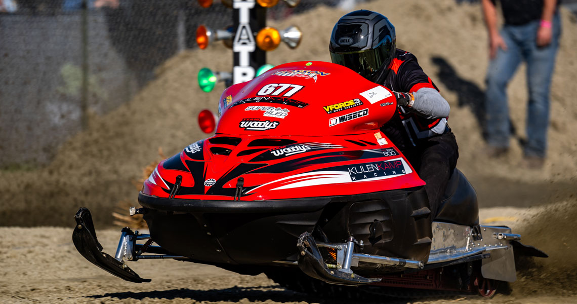 Snowmobile grass drags racer at race into winter, New Hampshire grass drags.