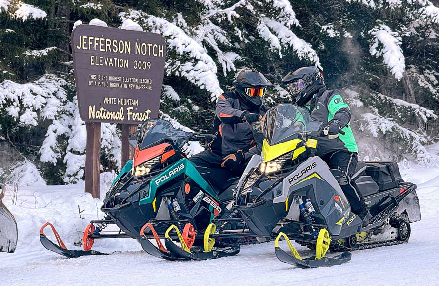 Snowmobile riders on Jefferson Notch Trail in New Hampshire. 